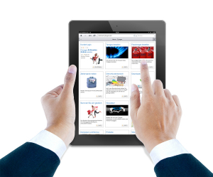 Hand hält ein iPad mit geöffneter Webseite